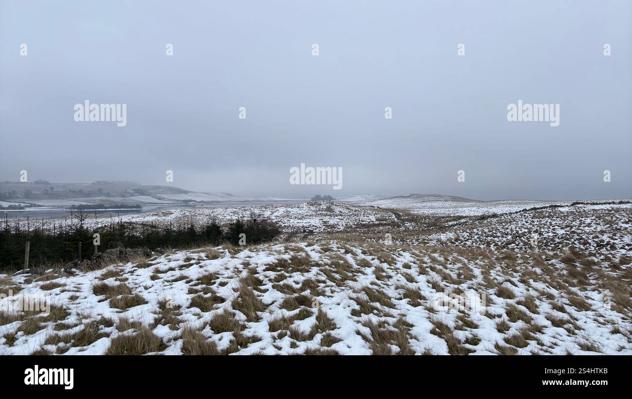 Open wide Scottish landscape in the winter. Snow and frost on the ground and in the distance, the Ballo Reservoir in Glen Vale, Scotland - Smartphone Captured Stock Image