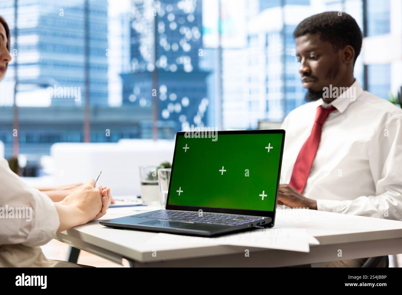 HR professional using green screen laptop during interview to ensure ...