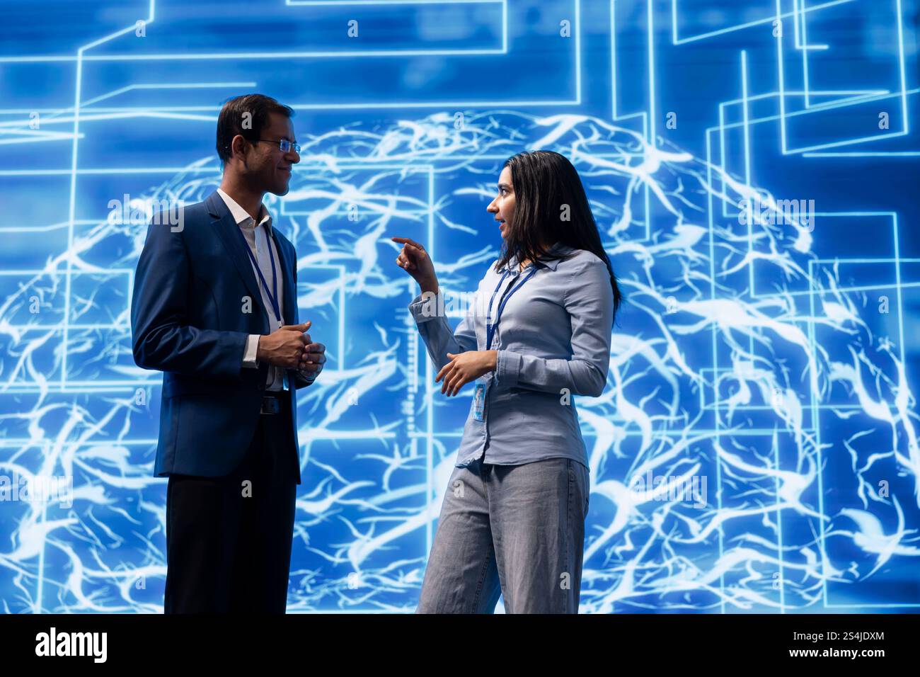 Engineering team colleagues doing brainstorming, analyzing AI models. Coworkers discussing, using machine learning to better understand and develop artificial intelligence Stock Photo