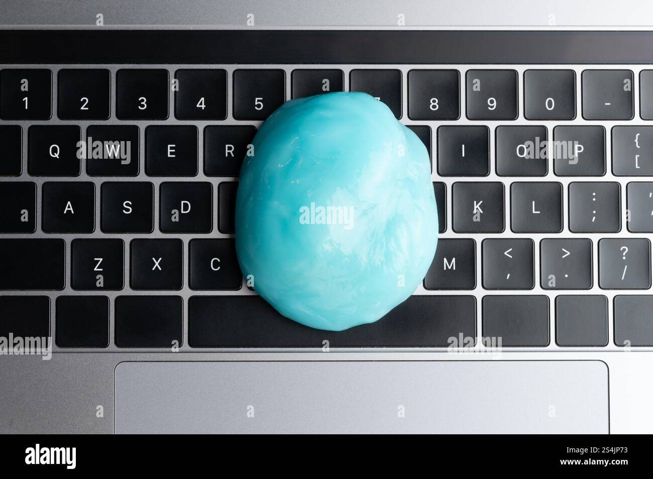 Big slime compound on black keyboard above top view Stock Photo