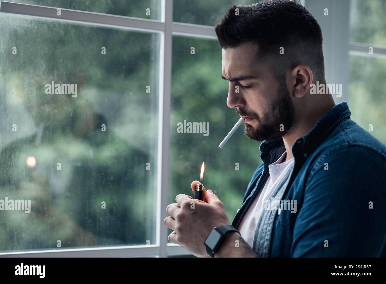 good looking depressed guy smoking a cigarette Depressed sad young man smoking hi-res stock photography and images
