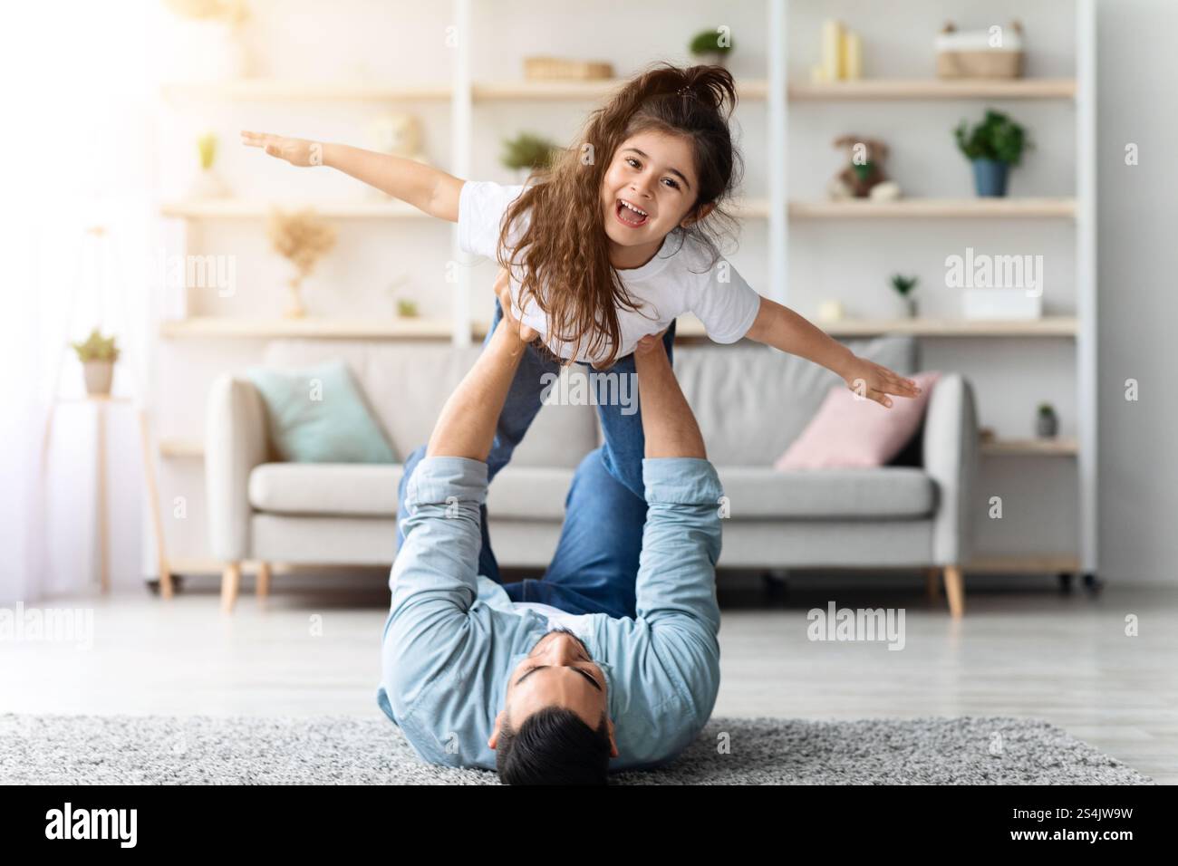 Happy dad and daughter playing together at home Stock Photo - Alamy