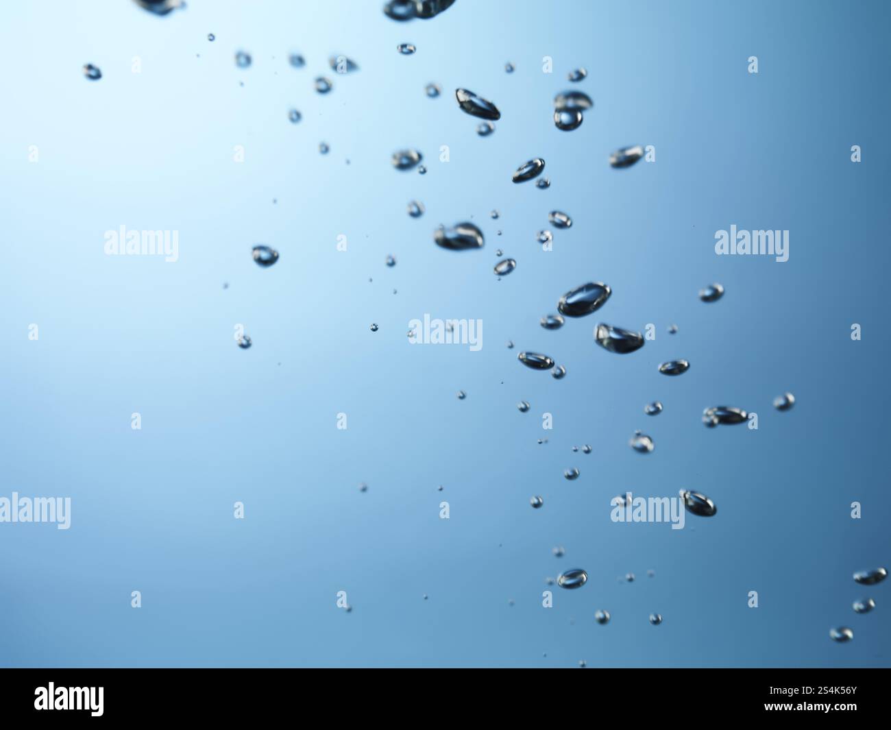 Oxygen bubbles rising to the surface of water with slight motion blur Stock Photo