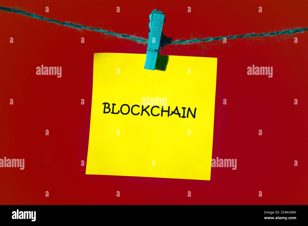 A bright yellow sticky note displays the word blockchain, symbolizing the technology's growing importance in business. Stock Photo