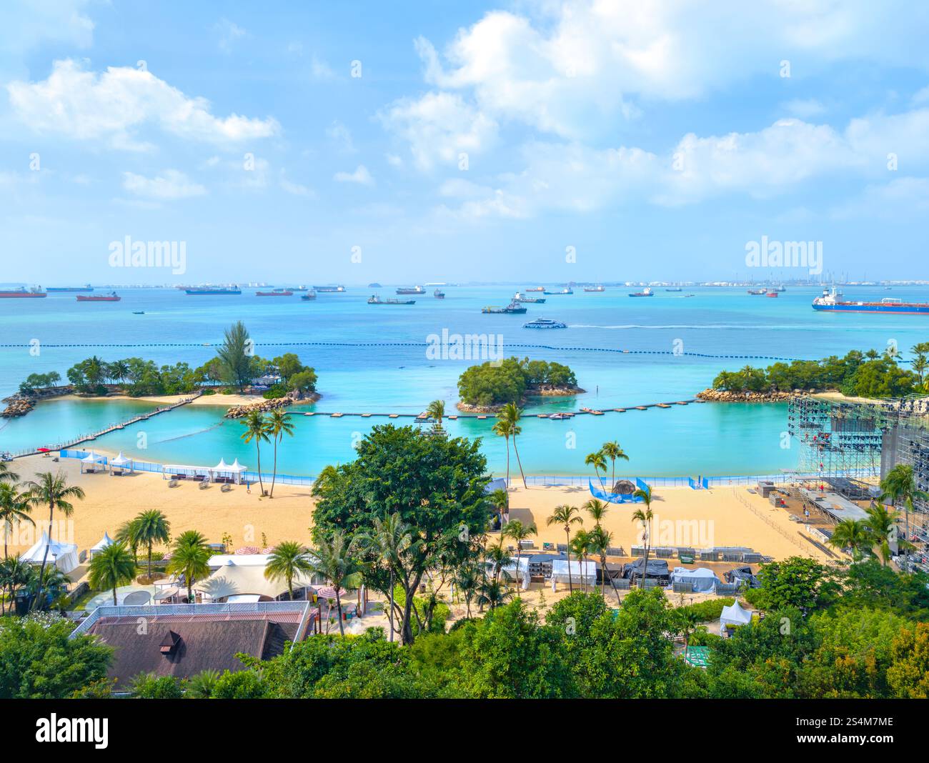 Singapore Sentosa Siloso Beach - Tropical Beach Scene With Palm Trees and Crystal Clear Water on Sunny Day Stock Photo