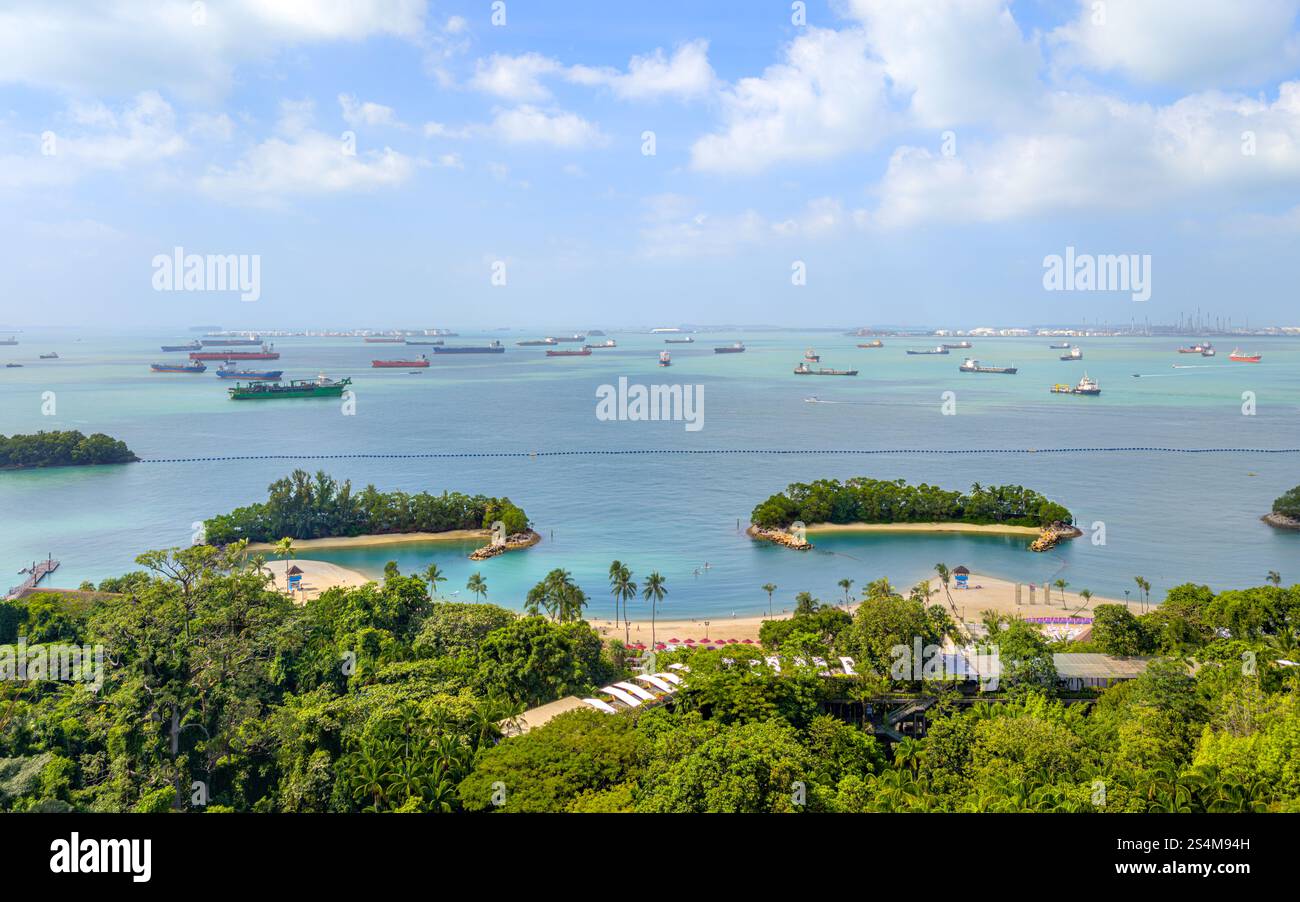 Singapore Sentosa Siloso Beach - Tropical Beach Scene With Palm Trees and Crystal Clear Water on Sunny Day Stock Photo