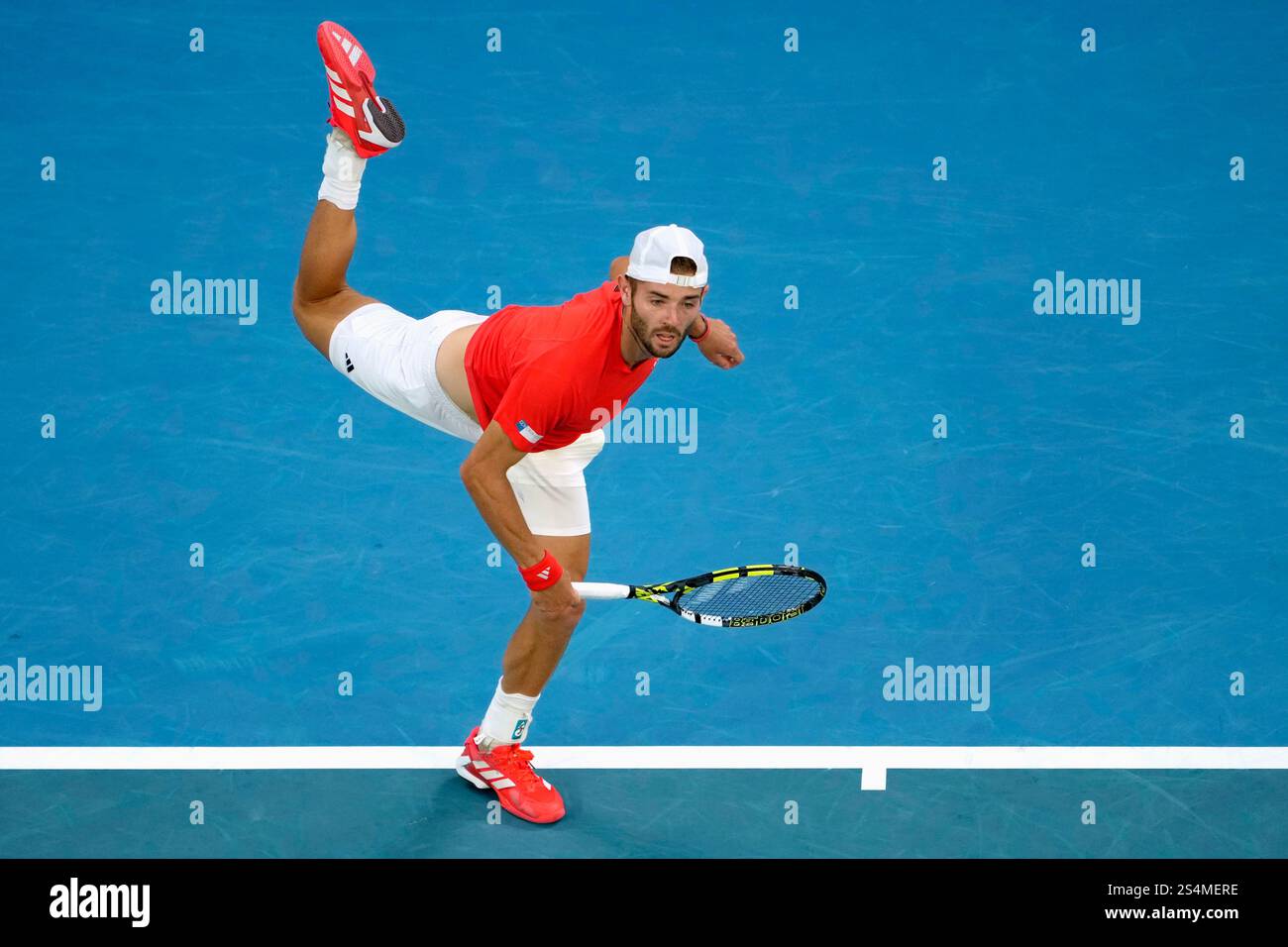 Jacob Fearnley of Britain serves to Nick Kyrgios of Australia during