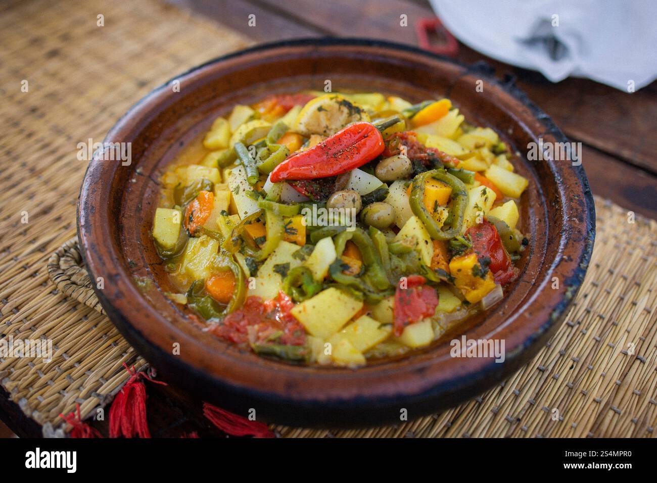Vegetable Tagine in Ceramic Pot on Woven Mat Stock Photo