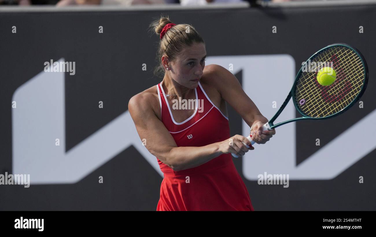 Marta Kostyuk of Ukraine plays a backhand return to Nao Hibino of Japan
