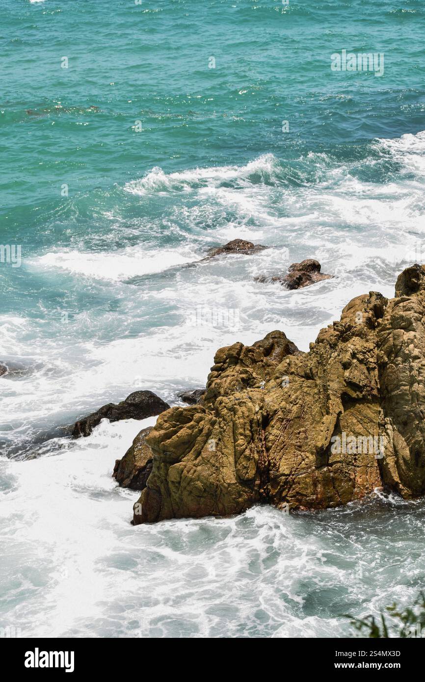 The Blue Sea Meets Rocky Shores in Puerto Escondido, Oaxaca Stock Photo ...