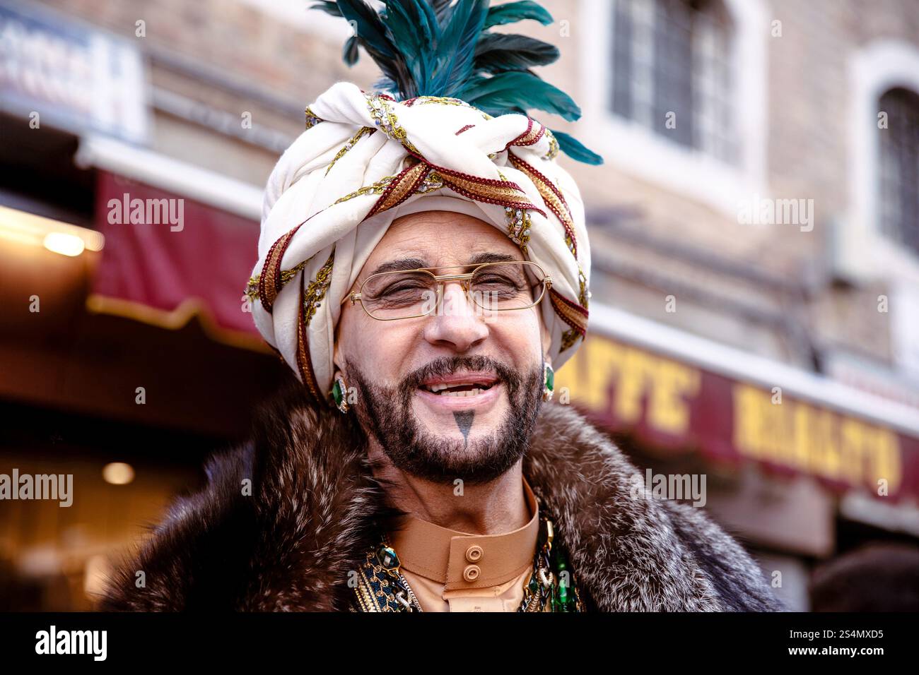 Man in traditional attire with turban and glasses smiling outdoo Stock Photo