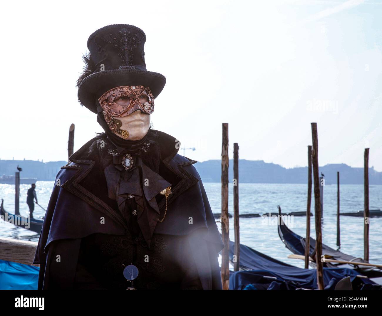 Steampunk masked figure standing by gondolas in venice Stock Photo - Alamy