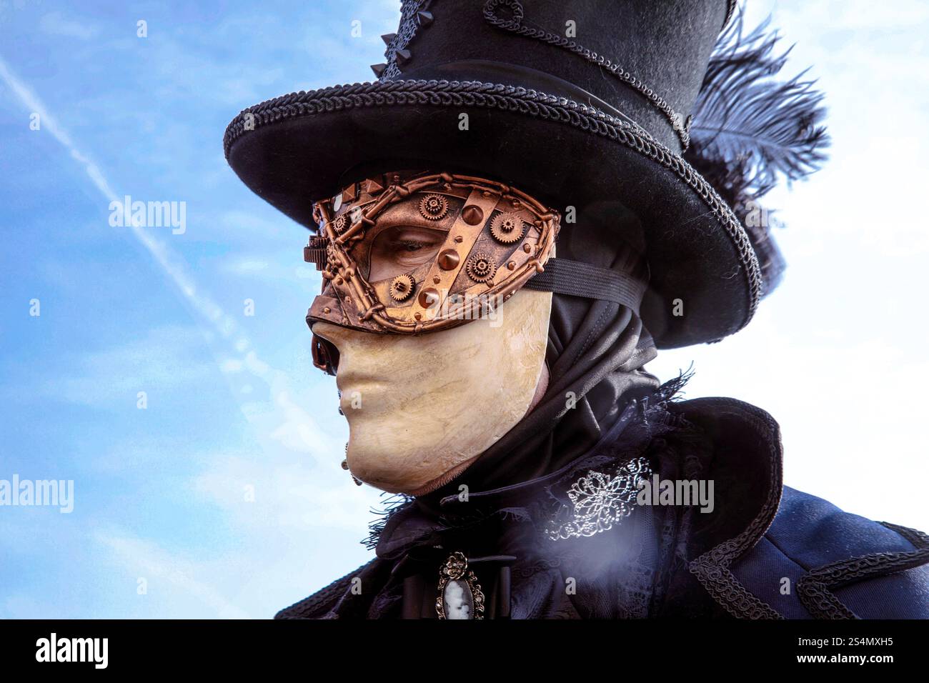Steampunk costume with masked male in vintage attire against blu Stock ...
