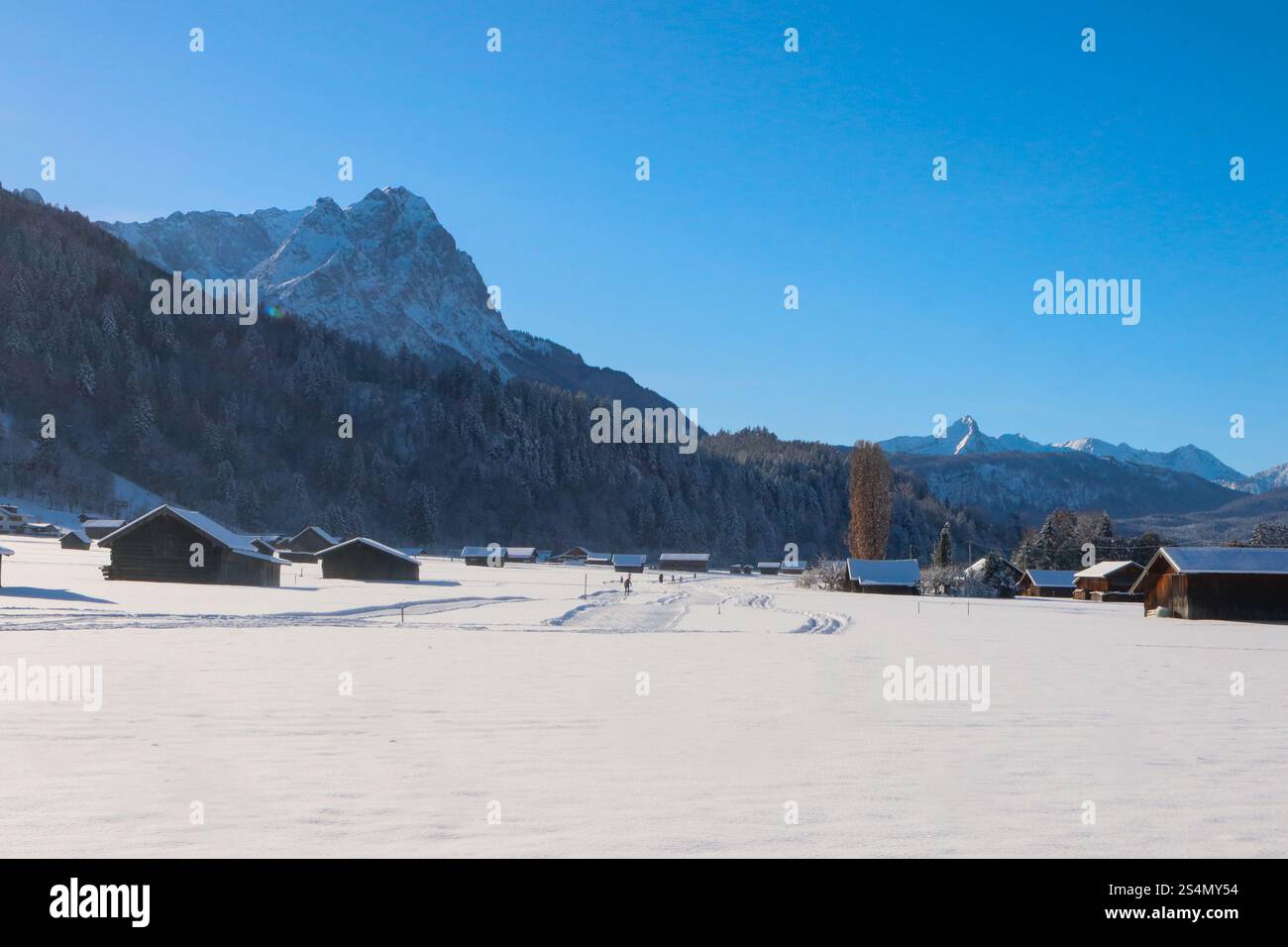 Winter landscape with cabins at the mountain base Stock Photo - Alamy