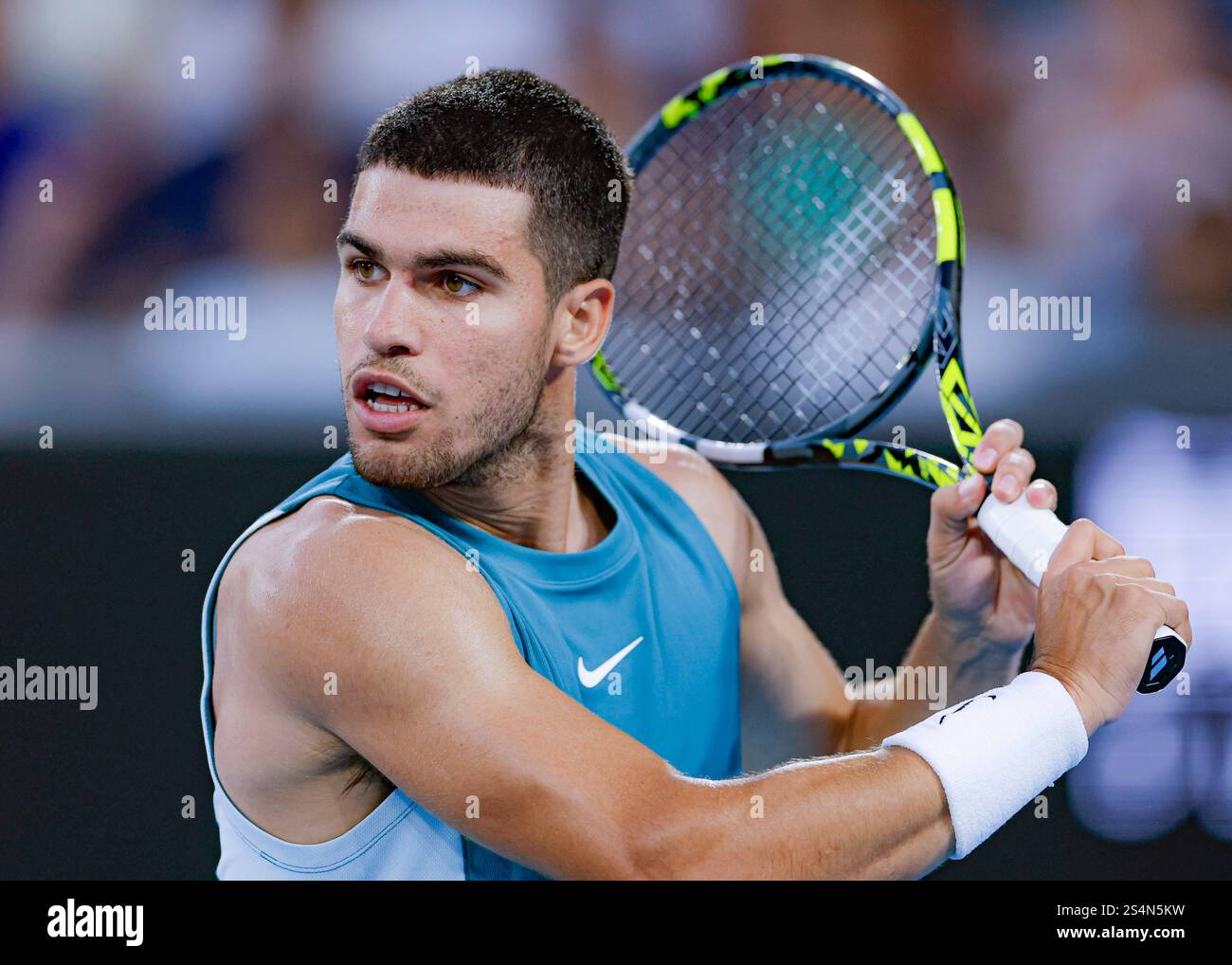 Melbourne, Australia. 13th Jan, 2025. Carlos Alcaraz hits a return during the men's singles first round match between Carlos Alcaraz of Spain and Alexander Shevchenko of Kazakhstan at Australian Open tennis tournament in Melbourne, Australia, Jan. 13, 2025. Credit: Chu Chen/Xinhua/Alamy Live News Stock Photo