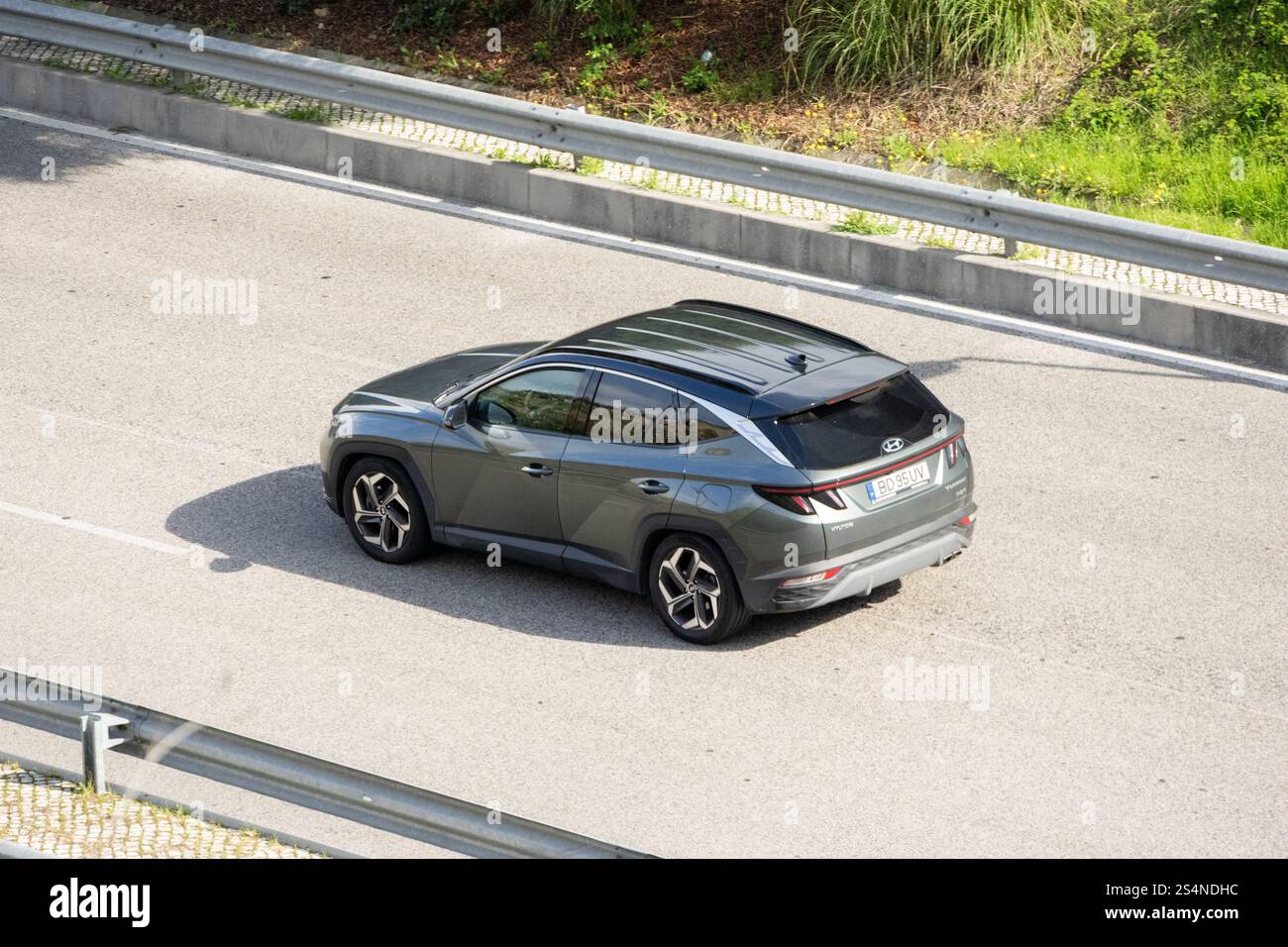 modern-suv-hyundai-tucson-driving-on-the-highway-on-a-sunny-day-stock