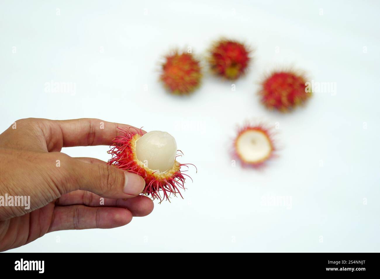 Hand holding peeled rambutan fruit hi-res stock photography and images ...