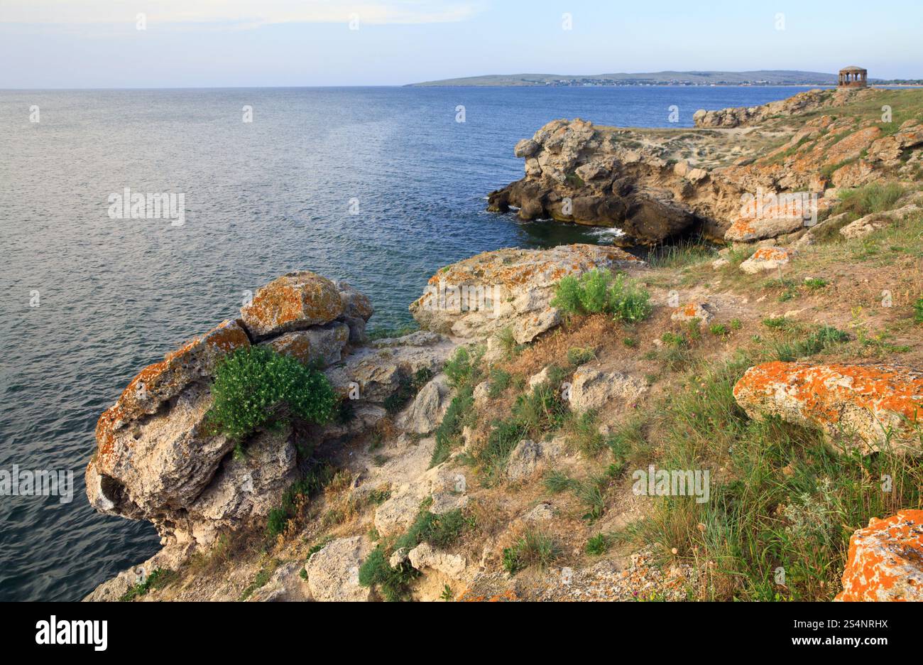 Rocky summer coastline and cape with pavilion Stock Photo - Alamy