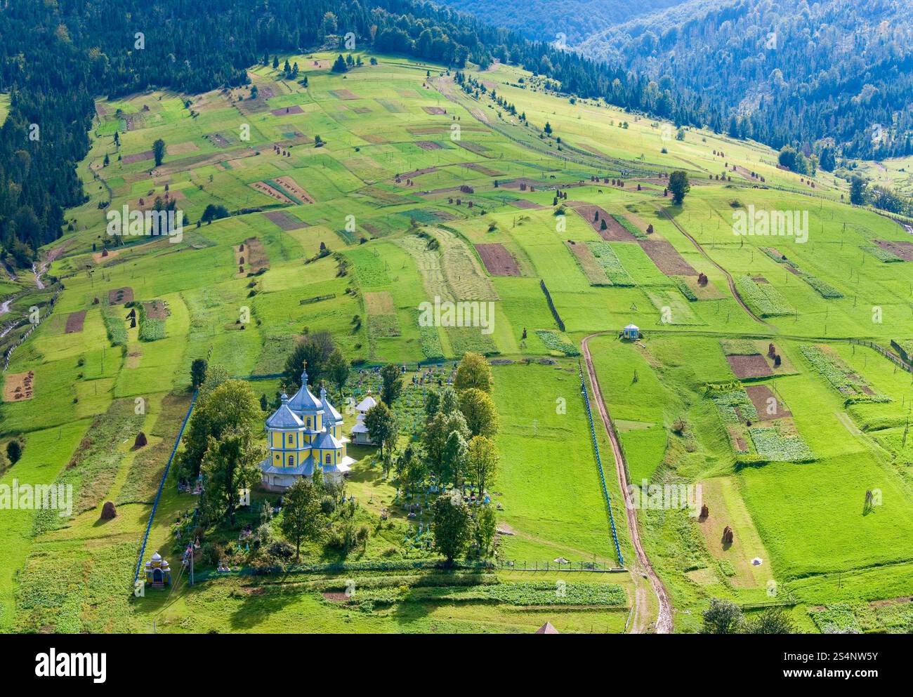 Beautiful small mountain village church on mountainside (Carpathian. Ukraine) Stock Photo