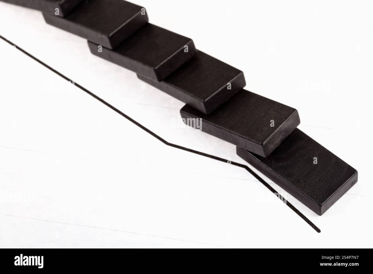 business concept - fallen domino and falling economy graph Stock Photo ...