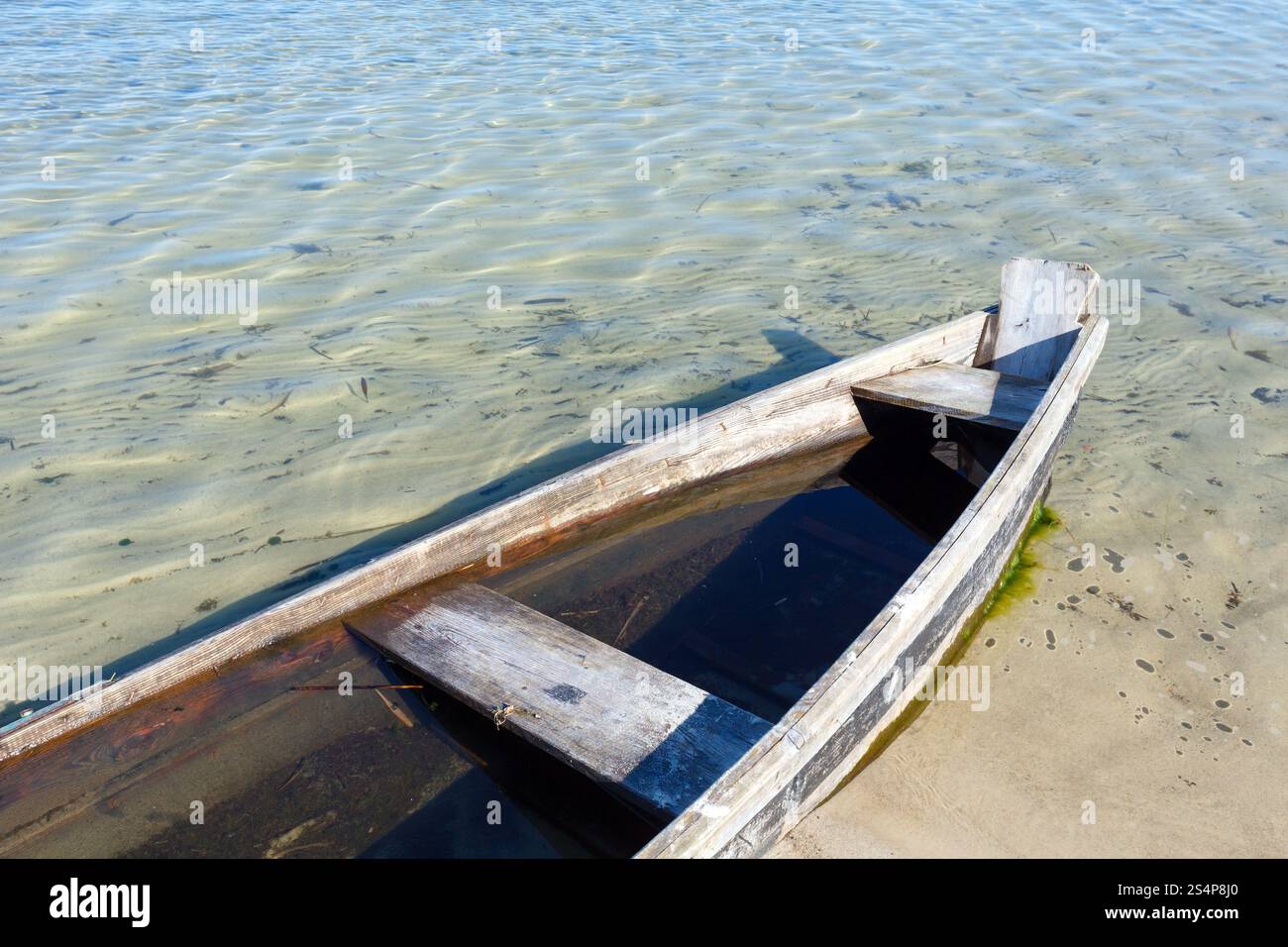 Old wooden fishing boat on summer lake bank Stock Photo - Alamy