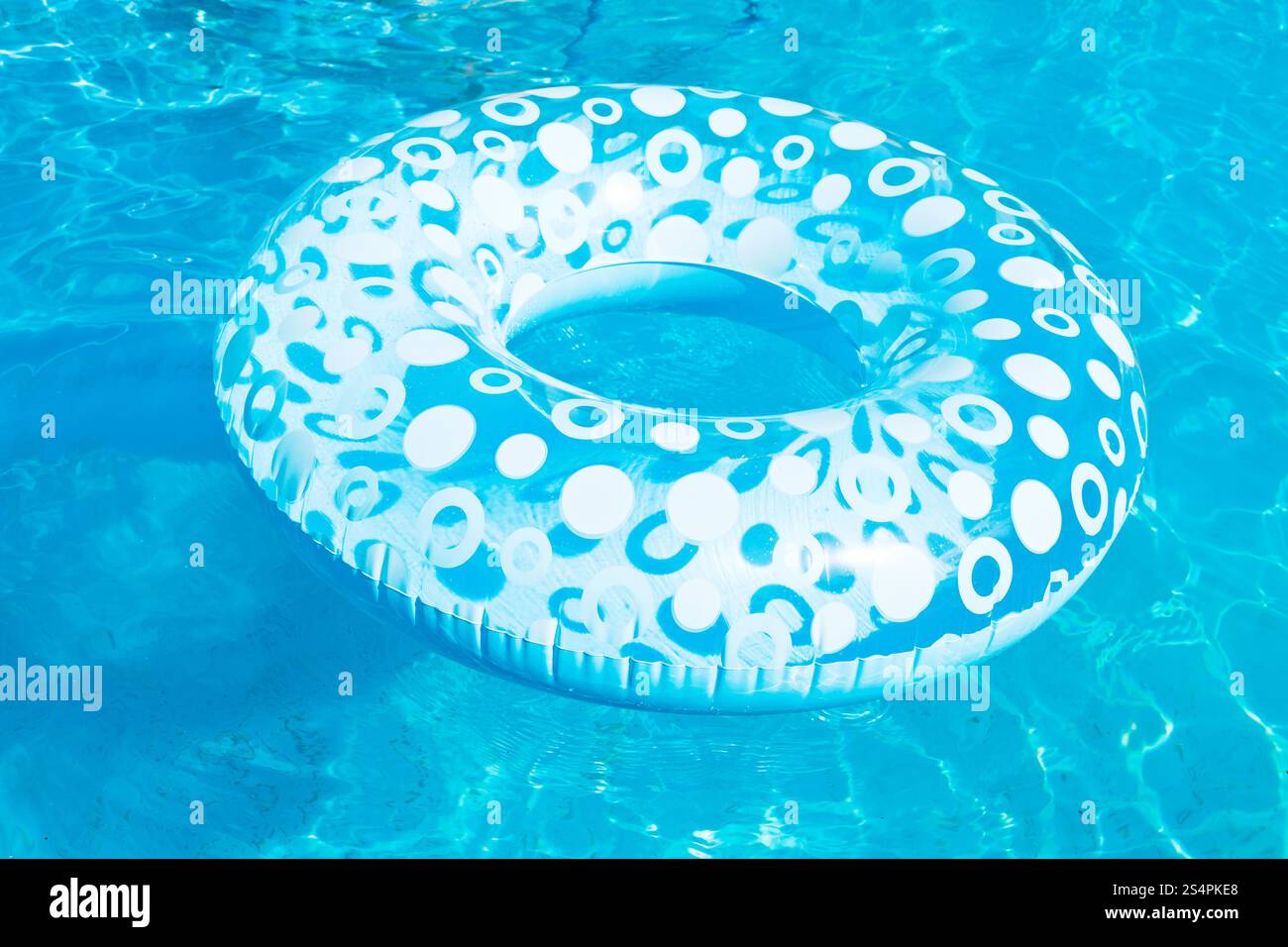inflatable swimming circle in blue open-air pool in summer day Stock Photo
