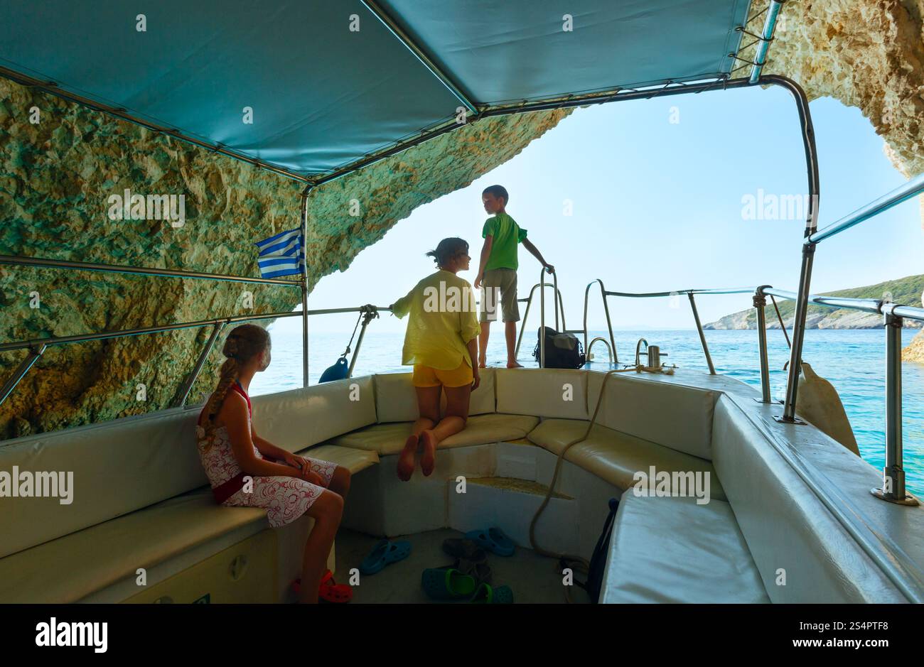 Family on boat in Blue Caves inside (Zakynthos, Greece, Cape Skinari ) Stock Photo
