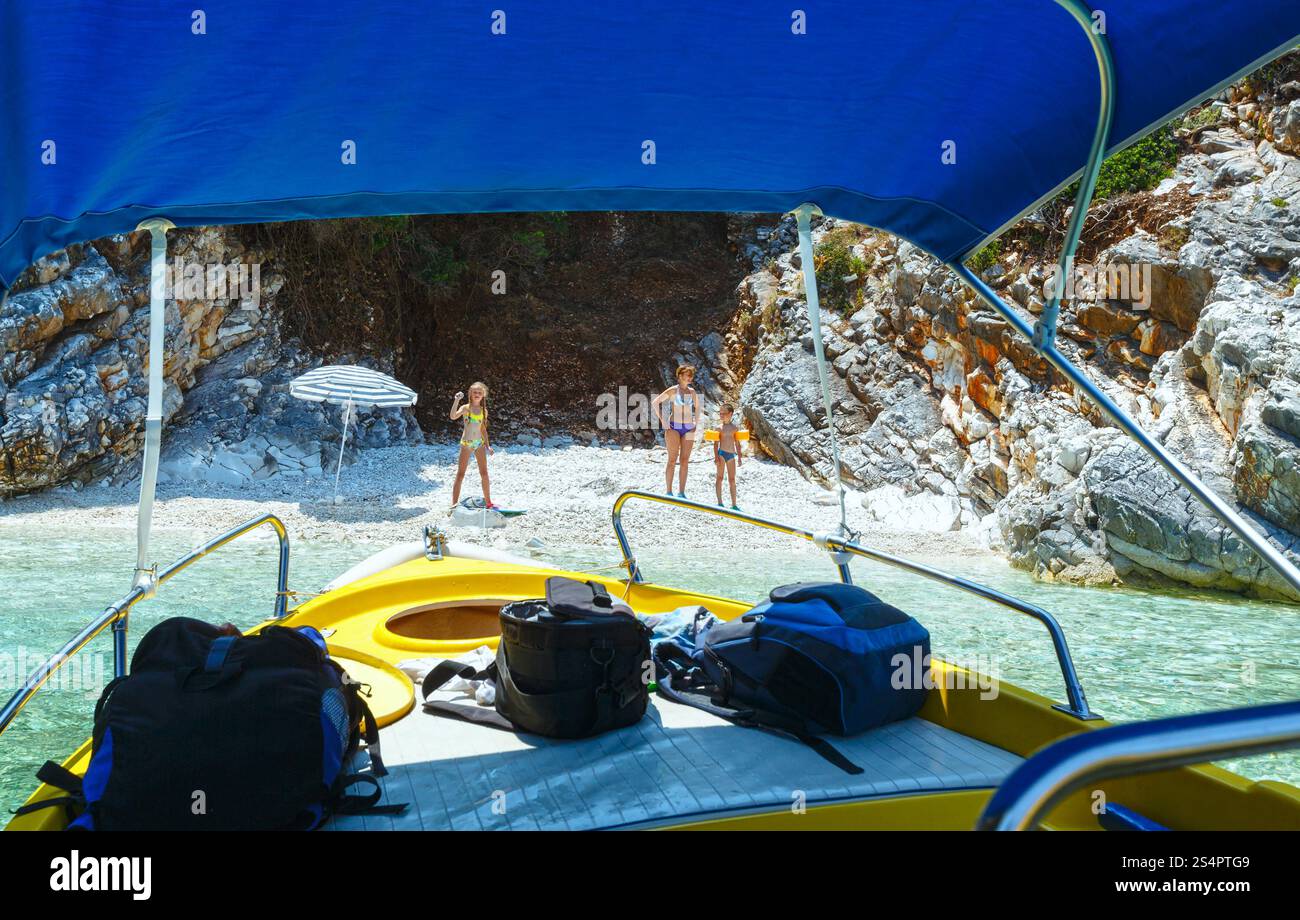 Family on one of small beaches not far from Agia Effimia (Kefalonia, Greece) Stock Photo