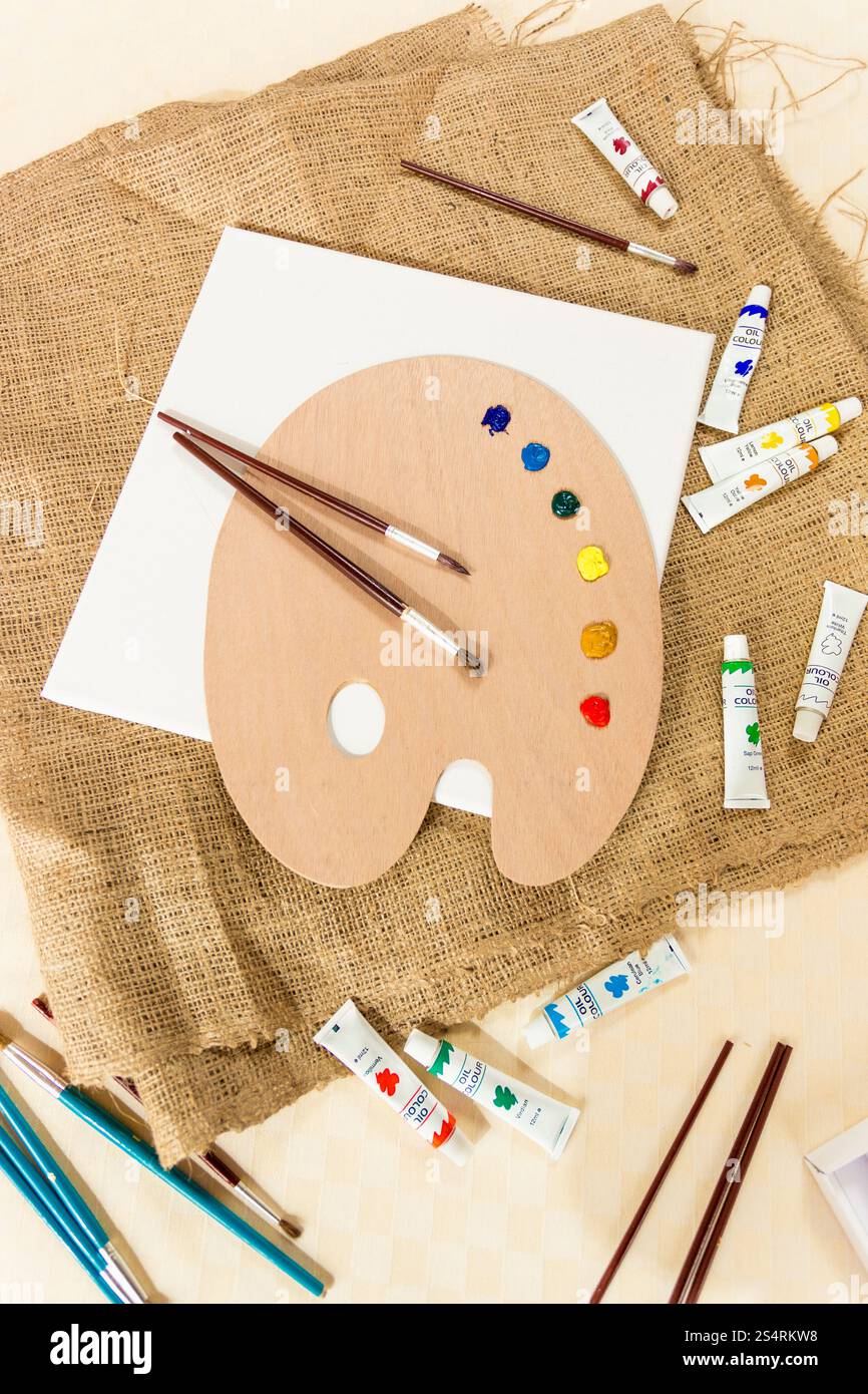 View from top on messy artist working space with lots of tools Stock Photo