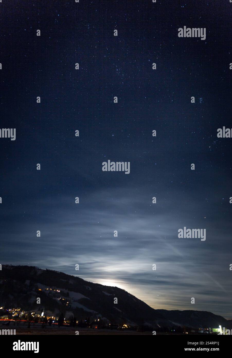 Beautiful view of mountain silhouette against starry nigh sky and shining moon Stock Photo