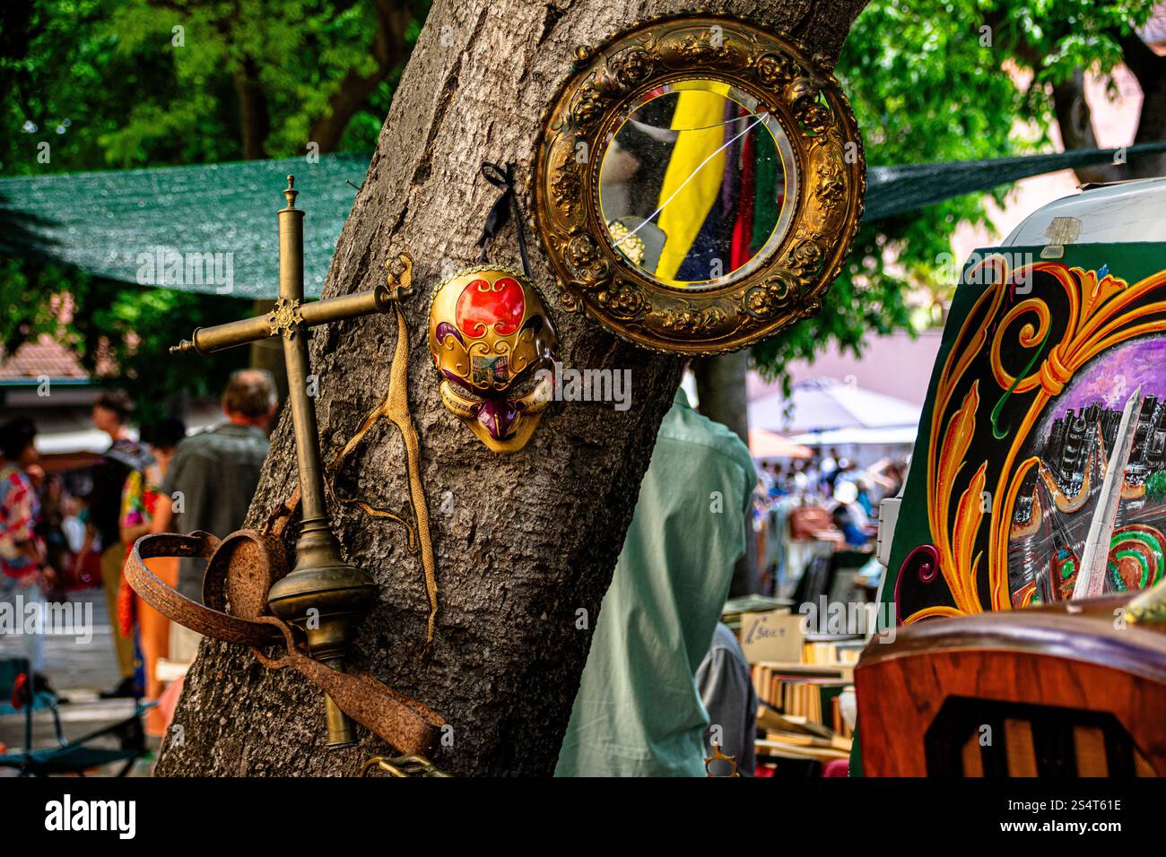 Feira da Ladra, Lisbon's flea market at Campo de Santa Clara, blends art and history with unique finds like mirrors, masks, and antiques by the trees. Stock Photo