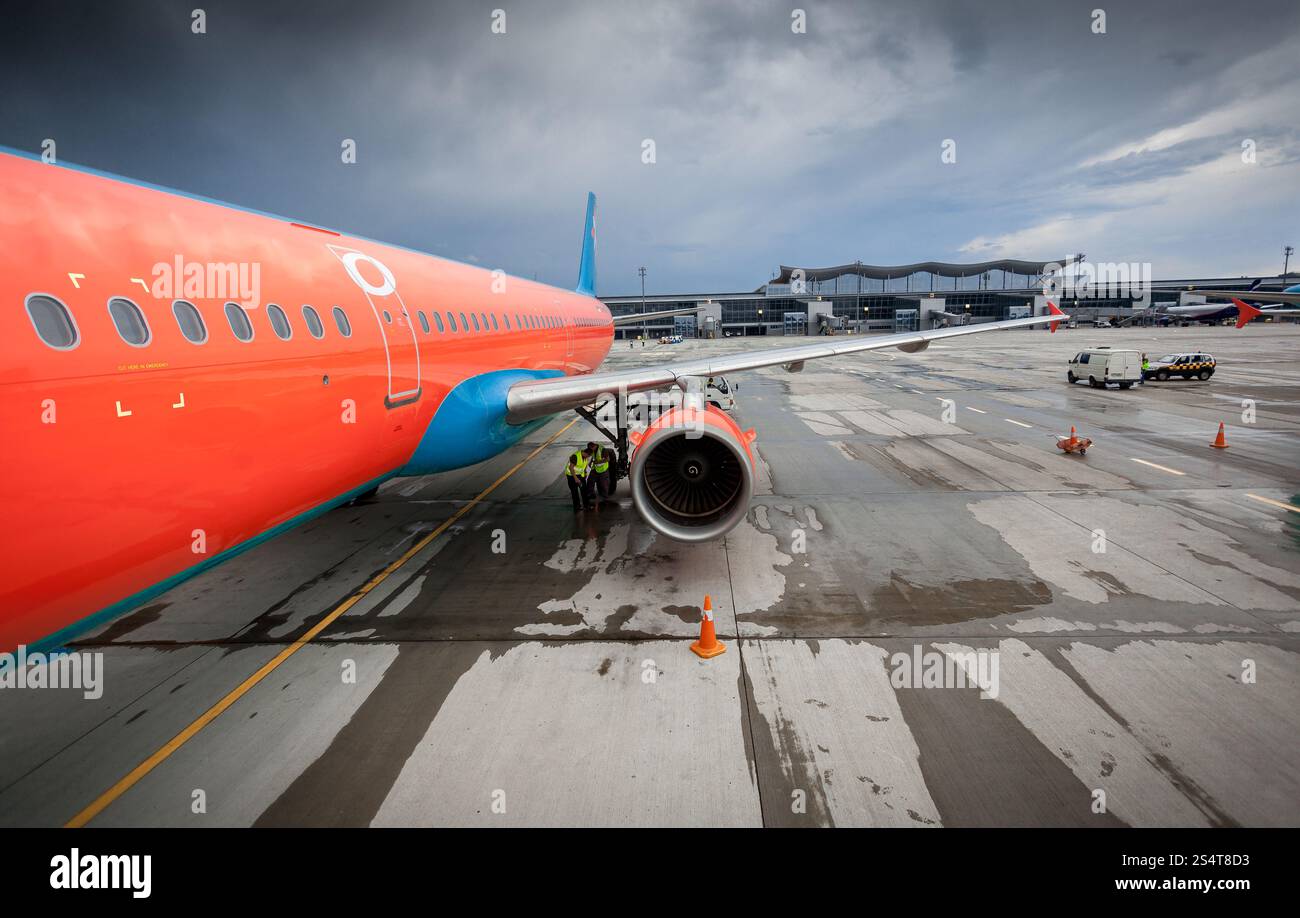 Big civilian airliner with jet engine on runway at storm Stock Photo