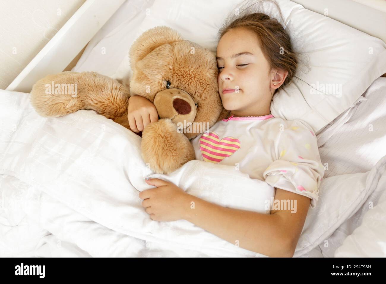 Little cute girl sleeping and hugging big teddy bear at bed Stock Photo ...