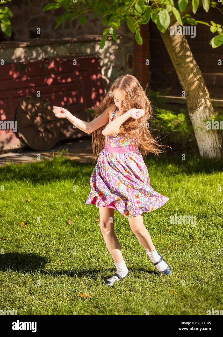 Beautiful young girl dancing on grass at sunny day Stock Photo - Alamy