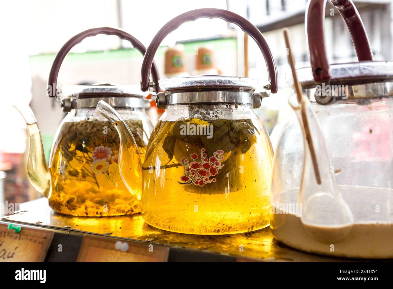 Closeup shot of three glass pots with fresh green tea Stock Photo