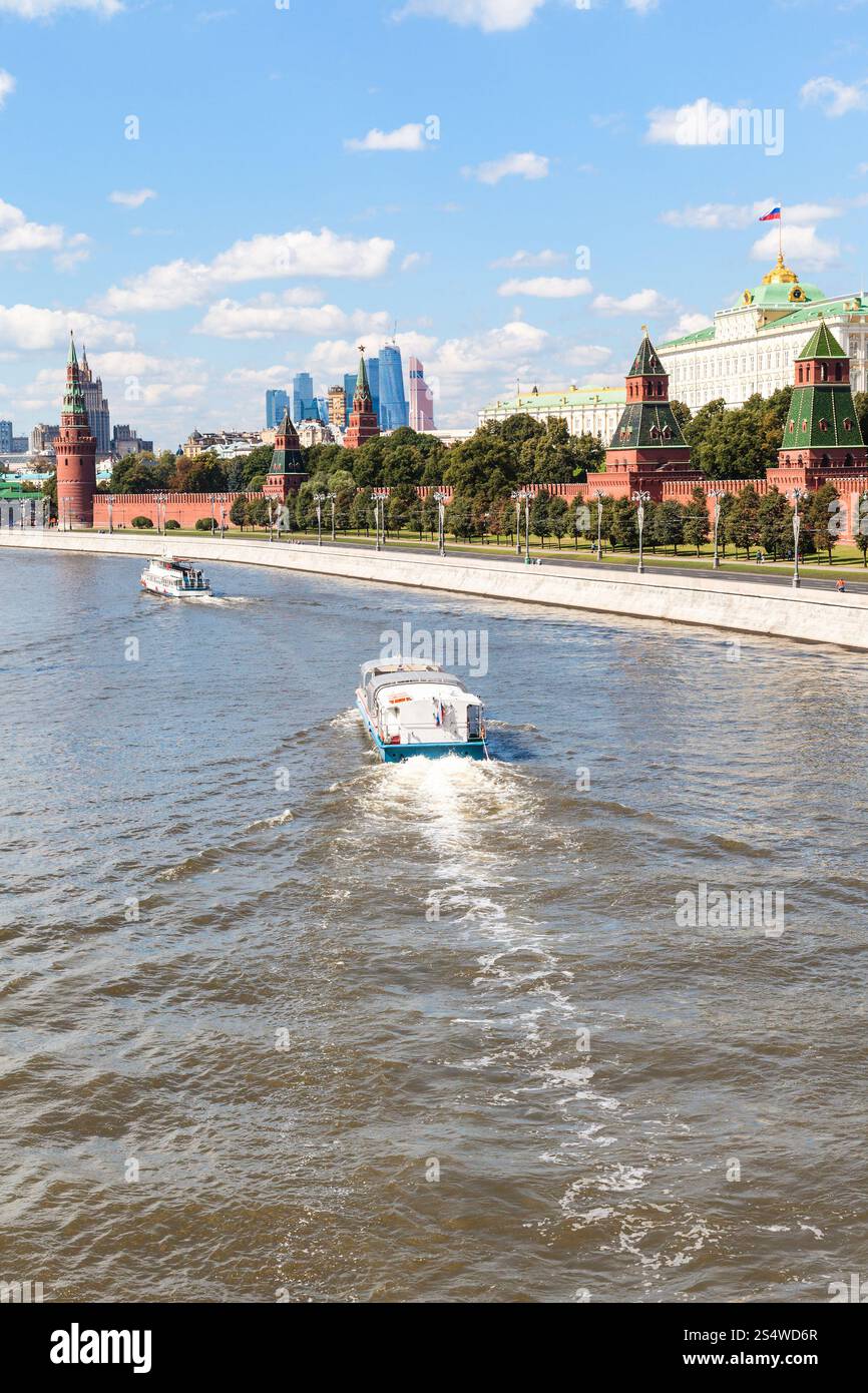 Moscow cityscape - boat in Moskva River, Kremlin, Moscow City district in sunny summer day Stock Photo