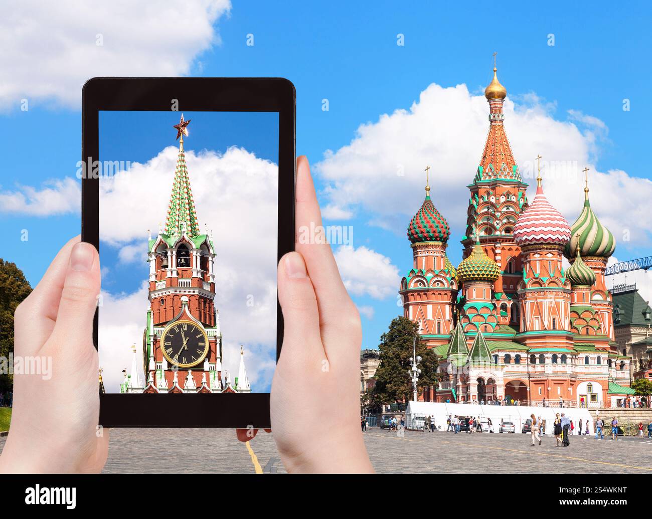 travel concept - tourist photographs picture of Vasilevsky Descent on Red Square in Moscow Kremlin on tablet pc Stock Photo