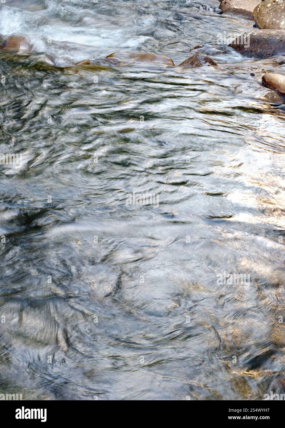 Mountain evening river surface with rapid current (background). Stock Photo