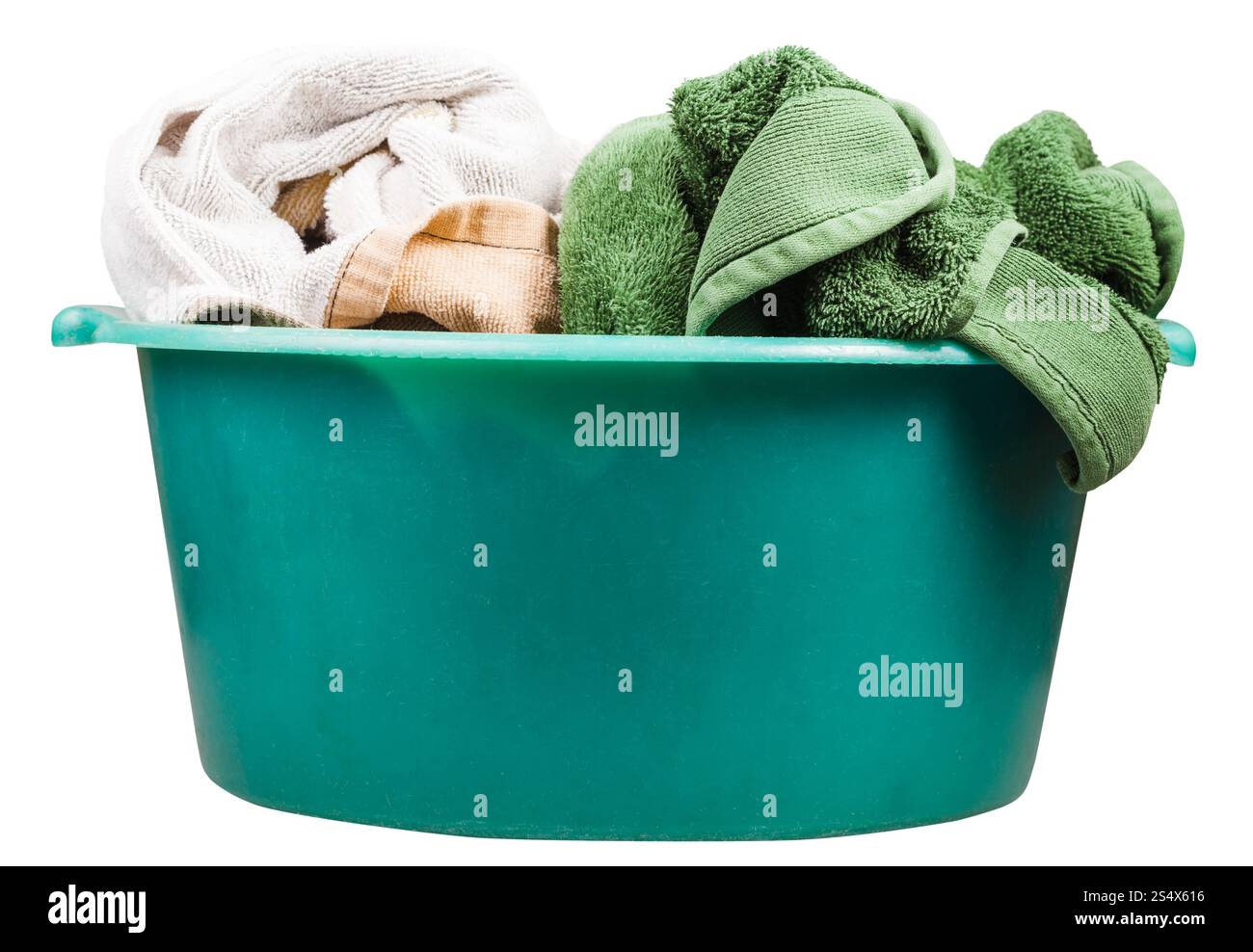 side view of round green plastic wash basin with towels isolated on white background Stock Photo