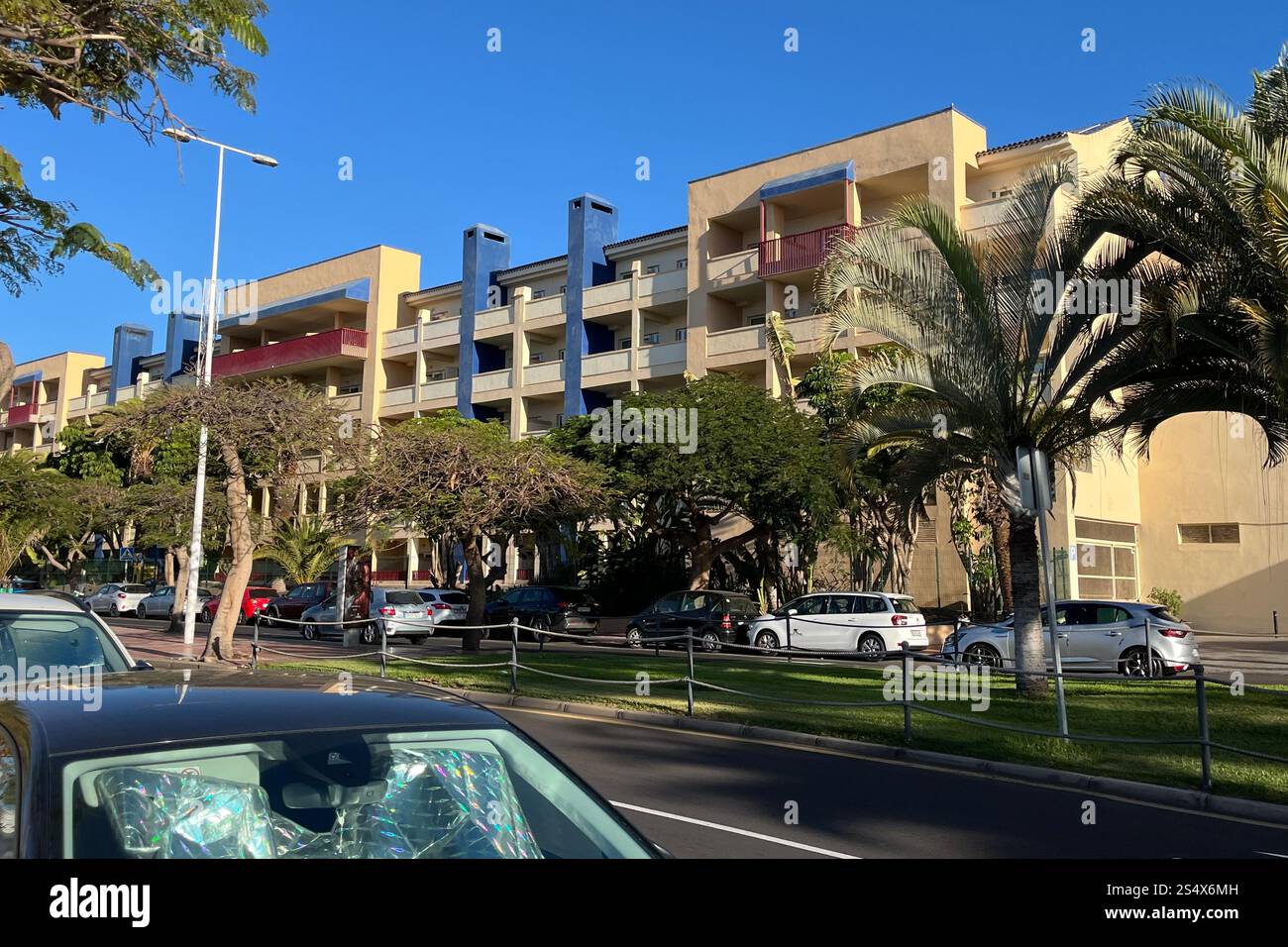 Cars parked across the street and outside the Hotel Best Jacaranda in Costa Adeje. Tenerife, Canary Islands, Spain. 11th January 2025. - Smartphone Captured Stock Image