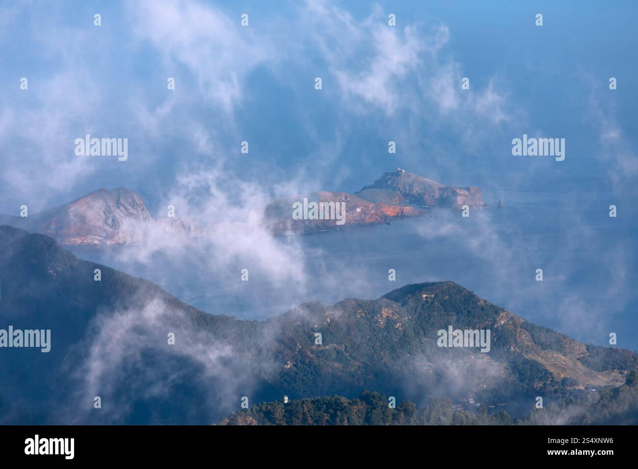 Aerial view of the ocean and mountains, showcasing the stunning ...