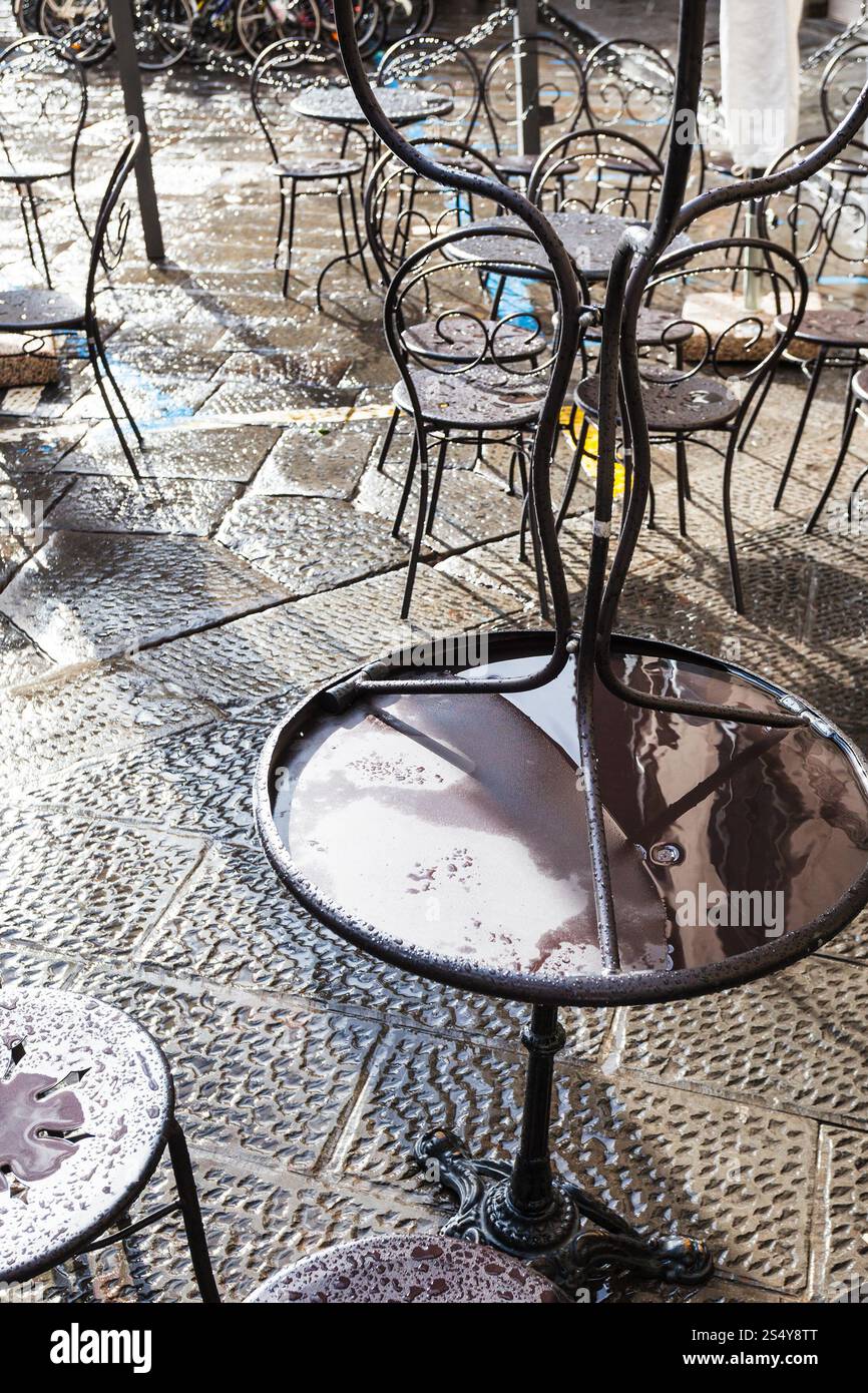 travel to Italy - wet tables in street cafe in Florence city after rain Stock Photo