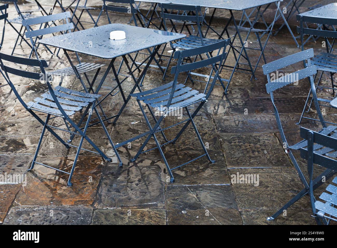 travel to Italy - wet tables in street restaurant in Florence city after autumn rain Stock Photo