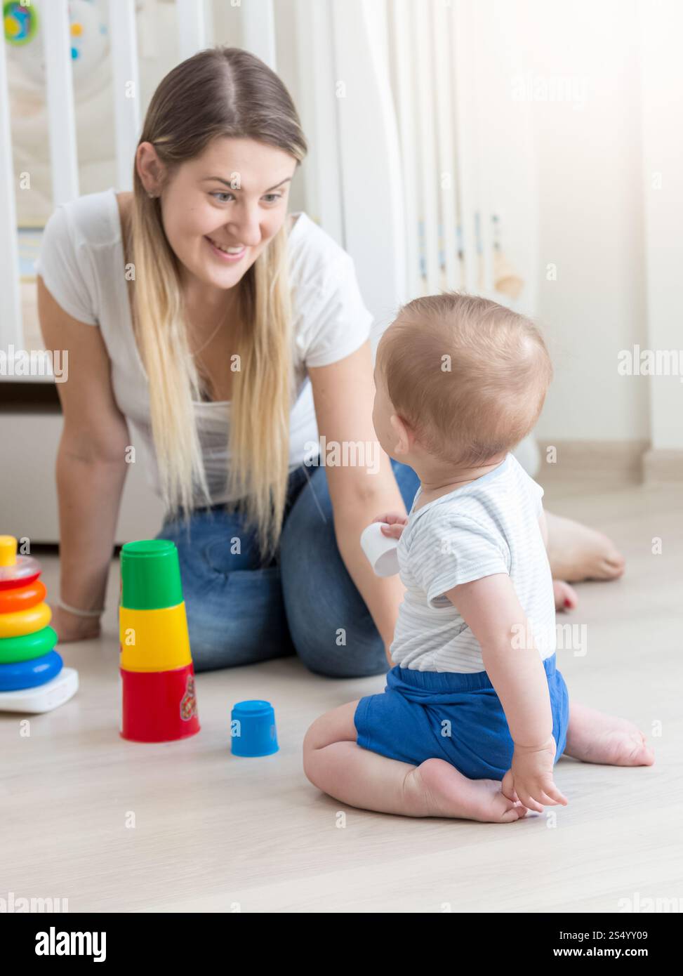 Smiling mother assembling toy pyramid with her baby boy Stock Photo - Alamy