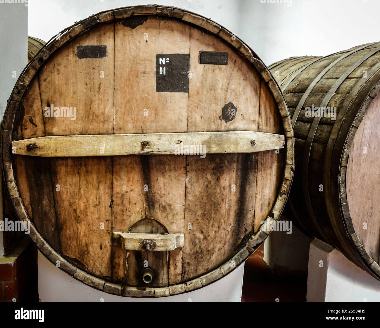 rows of wood wine barrels in a vintage winery cave. wood wine barrels ...