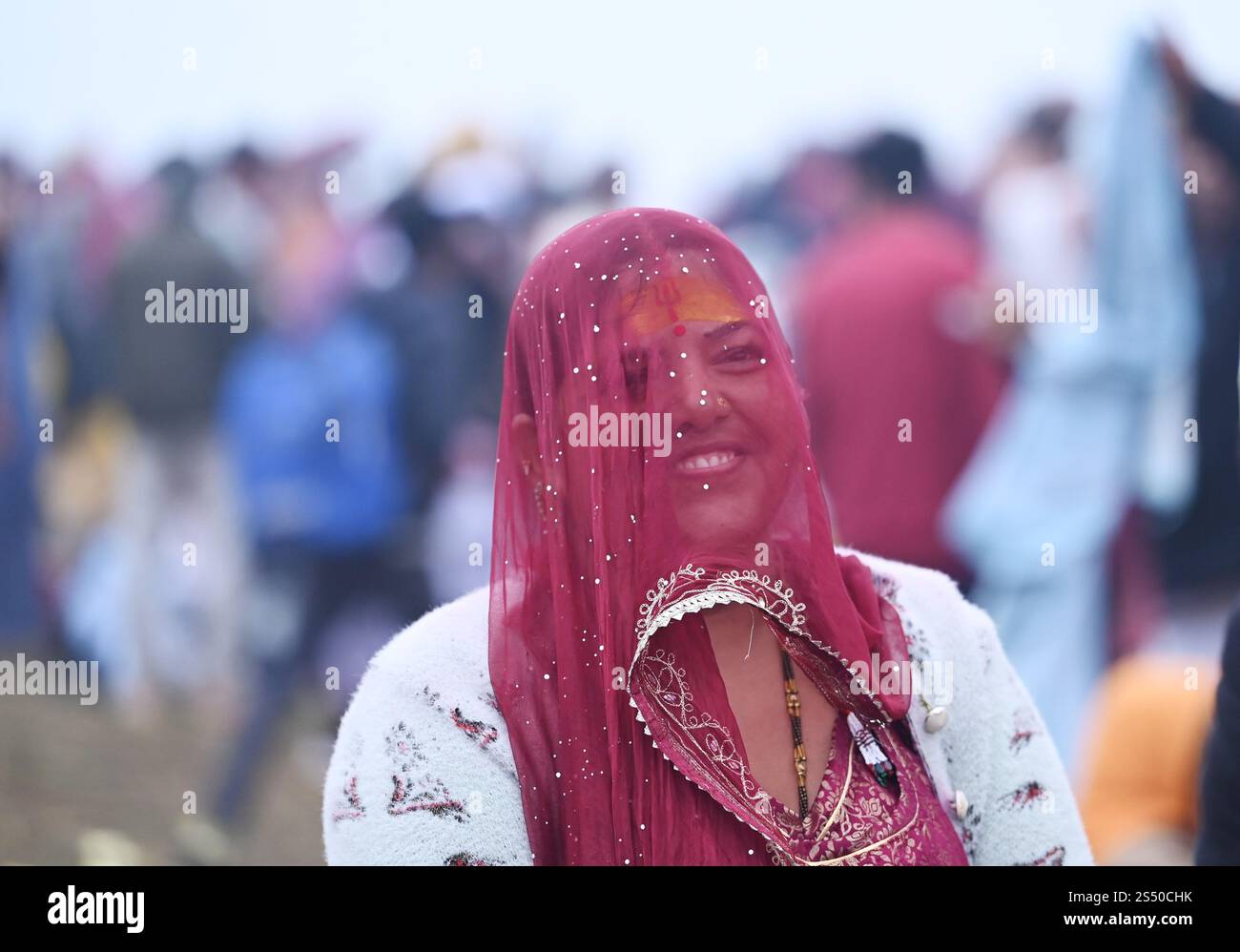 PRAYAGRAJ, INDIA JANUARY 13 Indian woman smiles after taking a dip