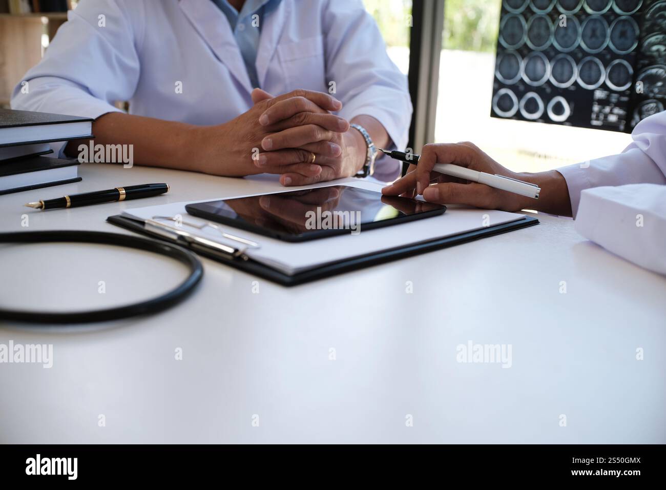 Education profession people and medicine concept close up of happy doctors with tablet and papers at seminar or hospital Stock Photo
