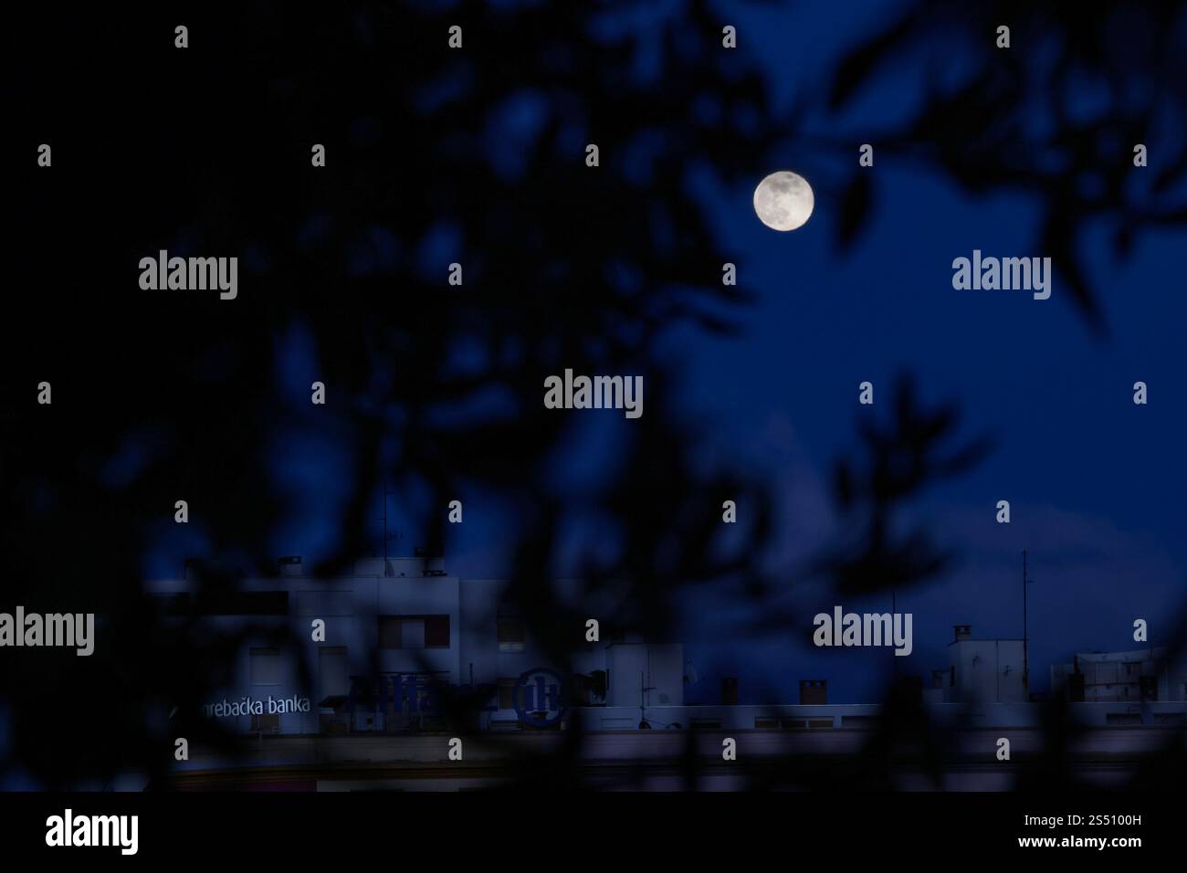 First full moon of 2025 also known as Wolf moon rises over city on
