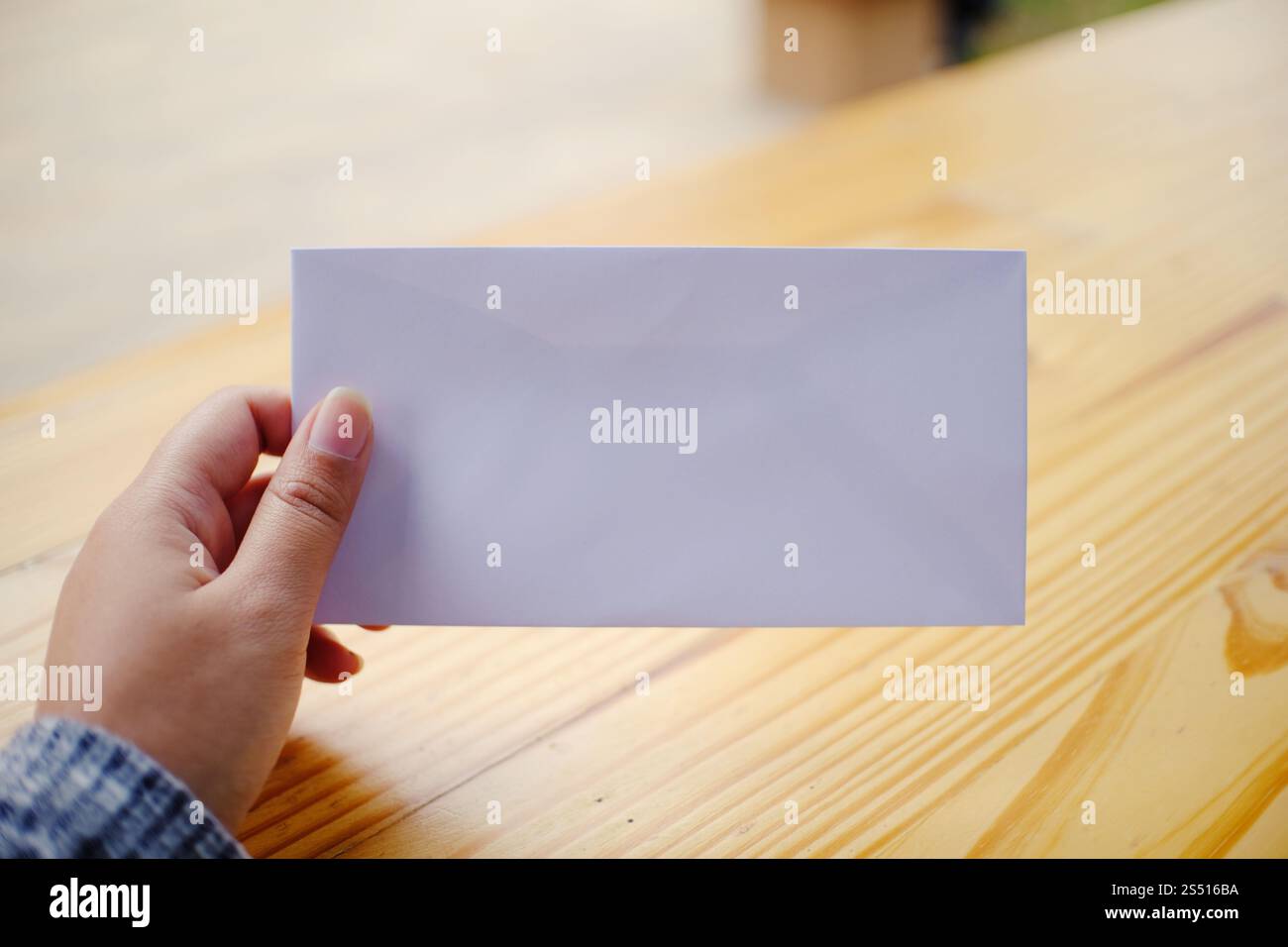 Woman hand hold the empty Envelope Letter Communication Stock Photo