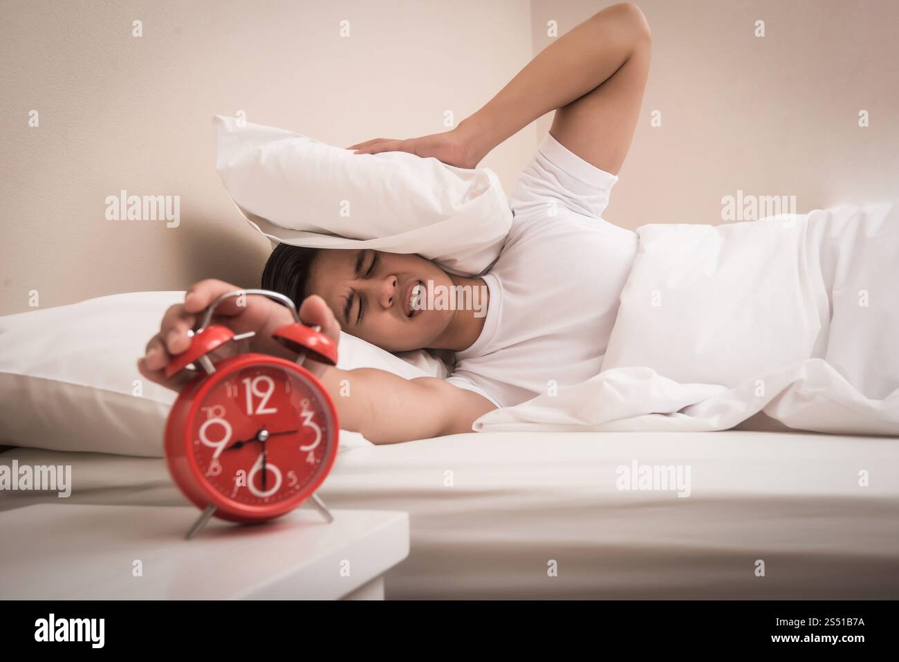 Man hand turns off the alarm clock waking up at morning . . Man hand turns off the alarm clock waking up at morning . Stock Photo